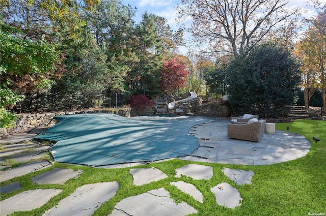 view of swimming pool with a patio area