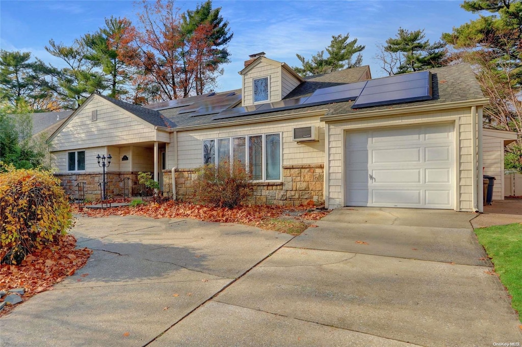 ranch-style house with solar panels and a garage