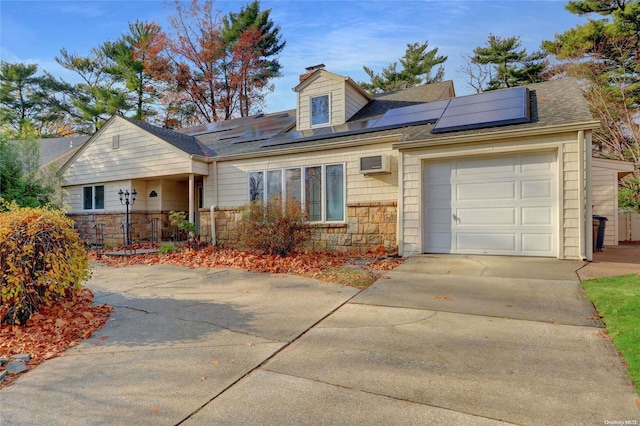 ranch-style house with solar panels and a garage