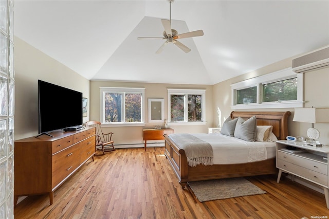 bedroom with a baseboard heating unit, vaulted ceiling, ceiling fan, a wall mounted AC, and light hardwood / wood-style floors