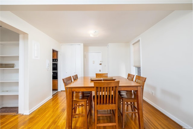 dining space with light hardwood / wood-style floors