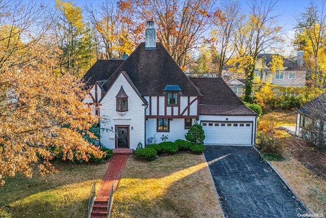 view of front of property with a garage and a front lawn