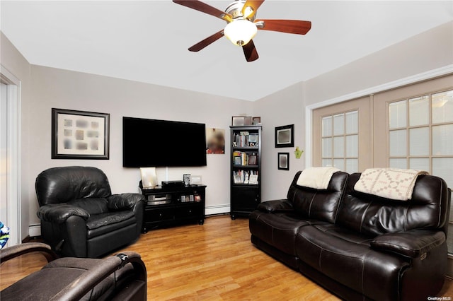 living room featuring ceiling fan, a baseboard radiator, and light wood-type flooring