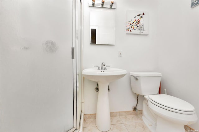 bathroom with tile patterned flooring, an enclosed shower, and toilet