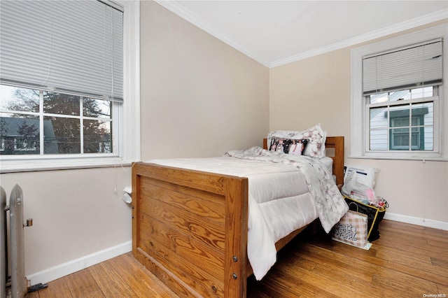 bedroom featuring hardwood / wood-style flooring and crown molding