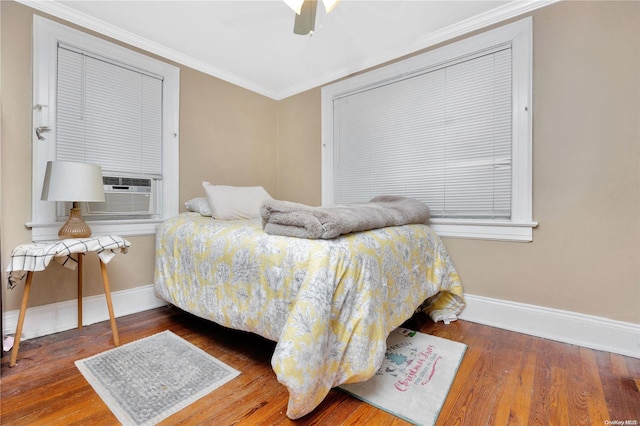 bedroom featuring hardwood / wood-style flooring, ceiling fan, cooling unit, and crown molding