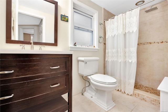 bathroom featuring tile patterned flooring, vanity, toilet, and walk in shower