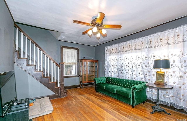 living room featuring hardwood / wood-style floors and ceiling fan