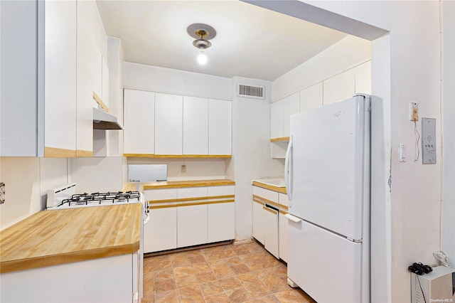 kitchen featuring white cabinets, white refrigerator, and range