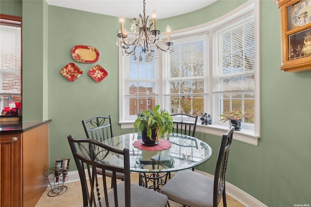 dining area featuring light tile patterned floors and a notable chandelier