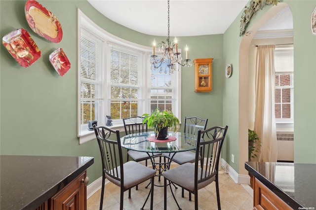 dining area with plenty of natural light, light tile patterned flooring, and a notable chandelier