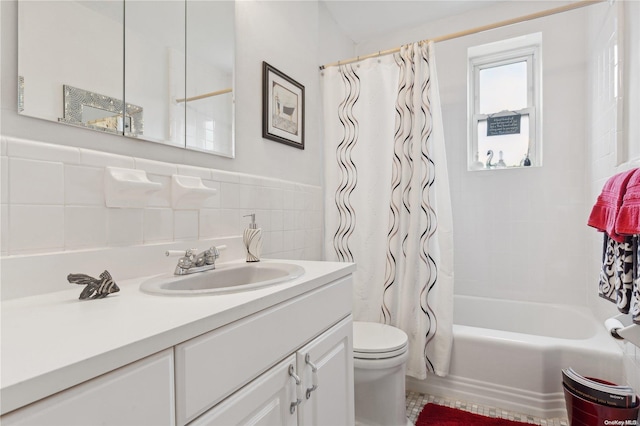 full bathroom with vanity, shower / bath combination with curtain, tile walls, and toilet