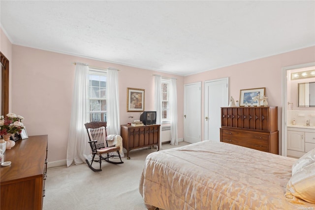 carpeted bedroom with radiator, ensuite bathroom, and a textured ceiling