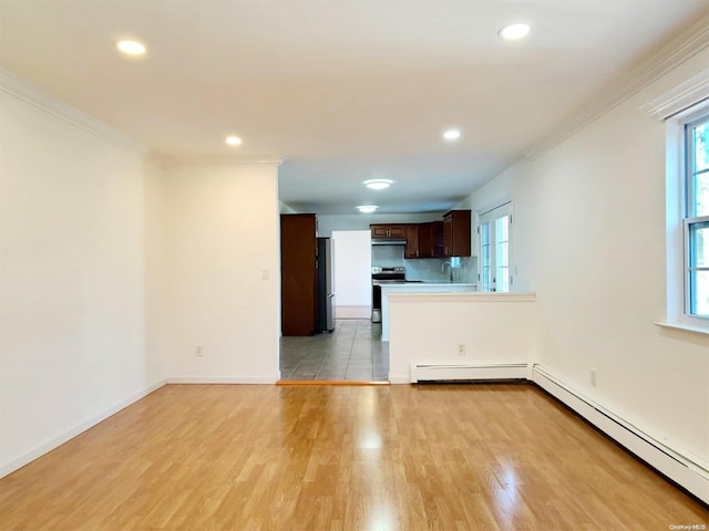 interior space with light hardwood / wood-style floors, crown molding, and baseboard heating