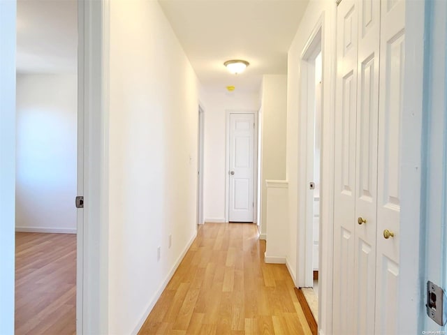 corridor with light wood-type flooring