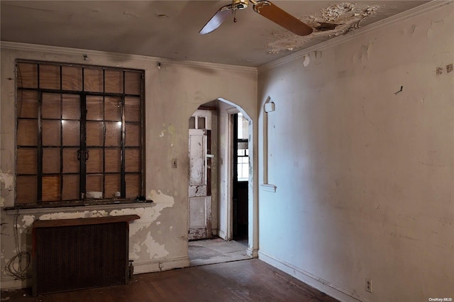 interior space with hardwood / wood-style flooring, ceiling fan, radiator heating unit, and ornamental molding