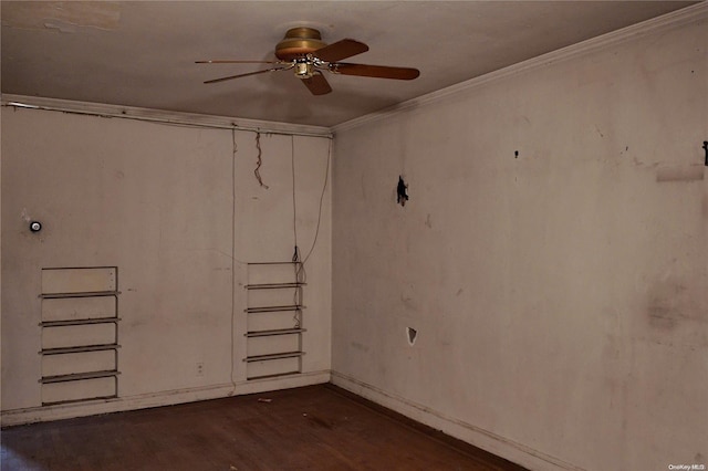 basement featuring dark hardwood / wood-style floors, ceiling fan, and ornamental molding