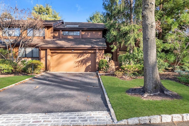 view of front of property with a front lawn and a garage