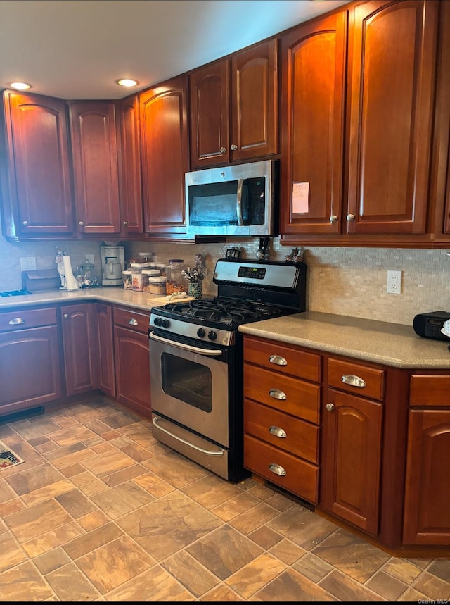 1661 Old Country Rd Unit 521, Riverhead, NY 11901 - kitchen featuring stainless steel appliances, tasteful backsplash, and light countertops