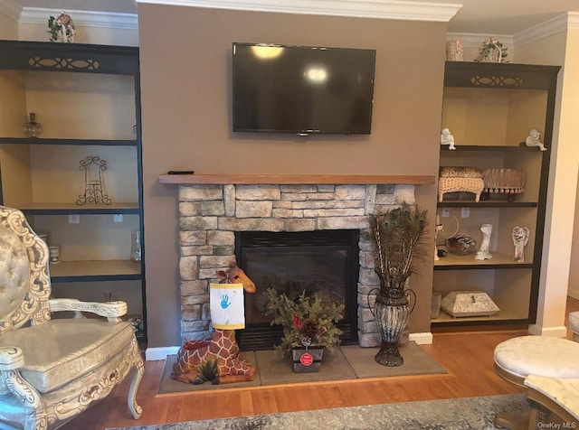 living room with a stone fireplace, dark hardwood / wood-style flooring, and ornamental molding