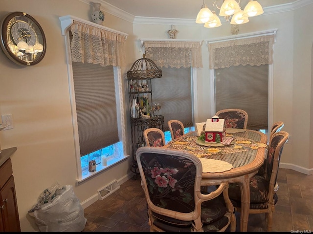 dining room with crown molding and a chandelier