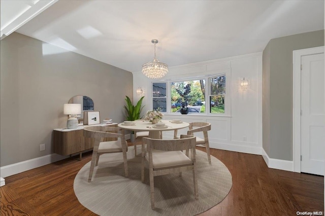 dining room featuring dark hardwood / wood-style flooring and an inviting chandelier