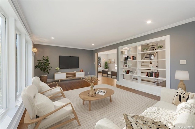 living room with hardwood / wood-style floors and crown molding