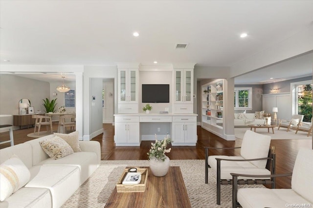 living room featuring a chandelier and dark hardwood / wood-style floors