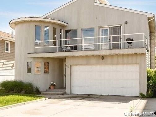 view of front facade with a balcony and a garage