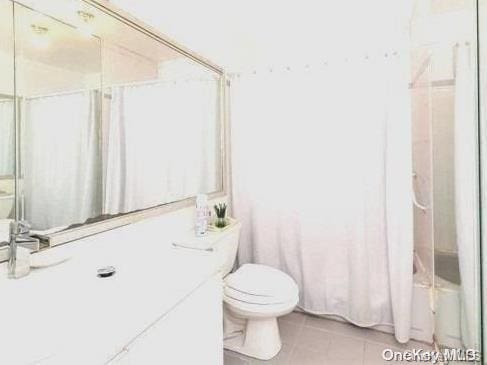 bathroom featuring tile patterned flooring, shower / bath combination, and toilet