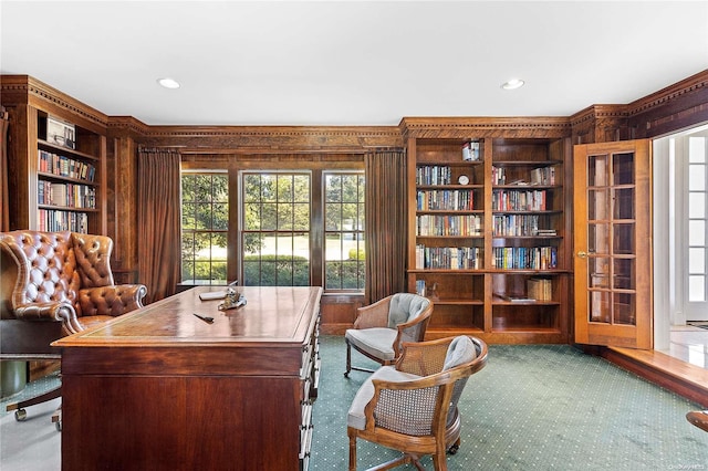 carpeted office featuring wood walls