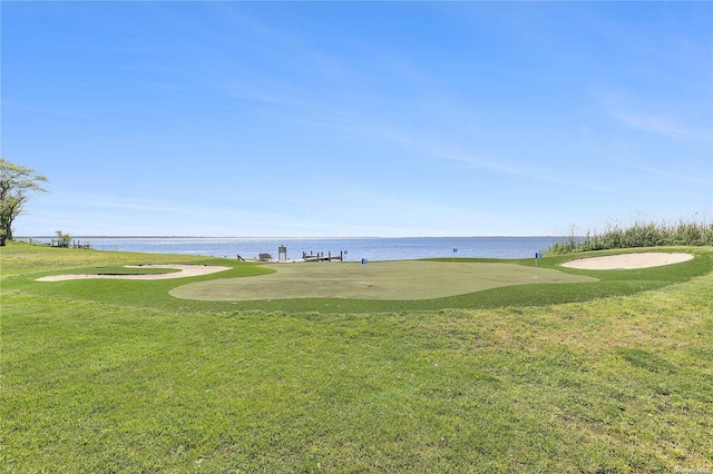 view of community featuring a yard and a water view