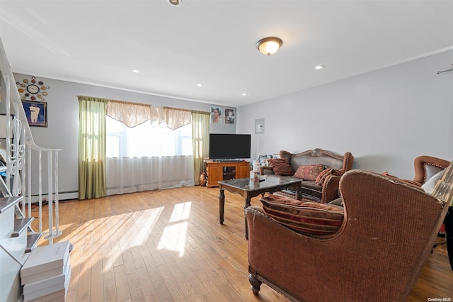 living room featuring light hardwood / wood-style floors and a baseboard heating unit