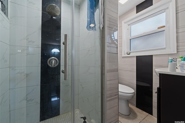 bathroom with toilet, vanity, tile walls, and walk in shower