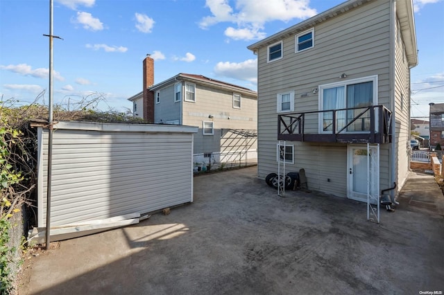 back of house with a balcony