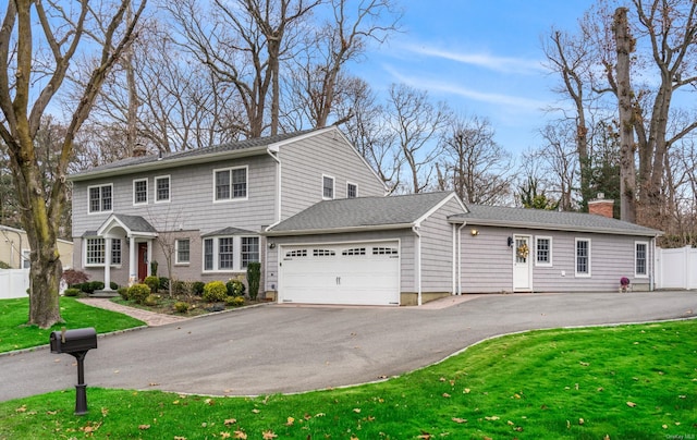 view of front of home with a garage and a front lawn