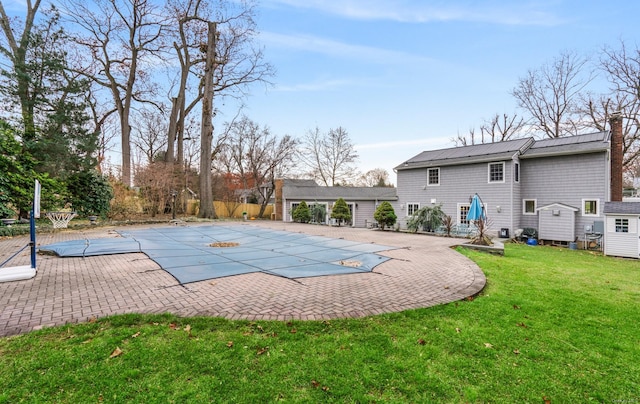 view of pool featuring a patio and a lawn