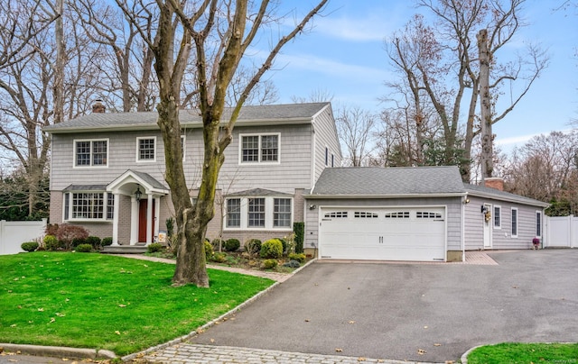 view of front of home with a front lawn and a garage