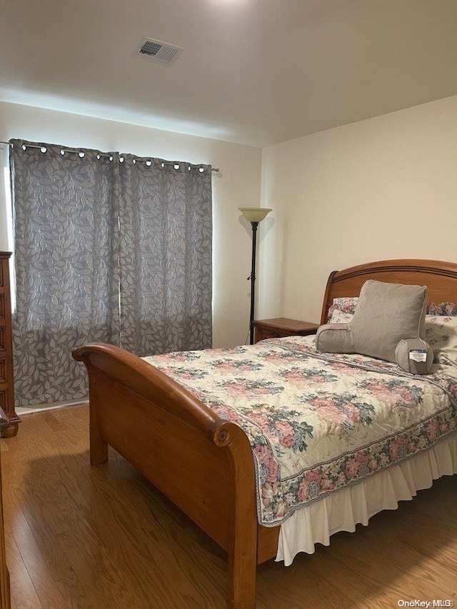 bedroom with wood-type flooring