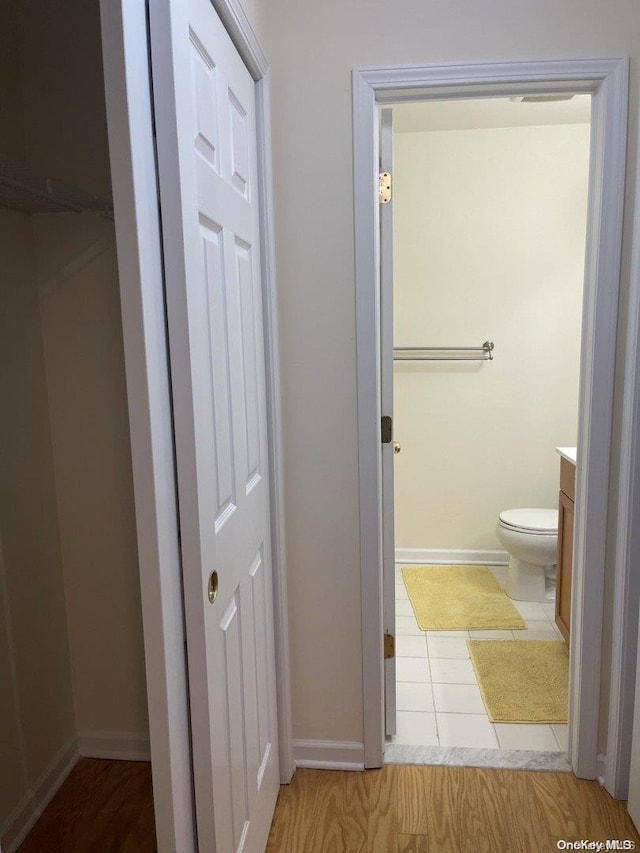 bathroom with hardwood / wood-style flooring, vanity, and toilet