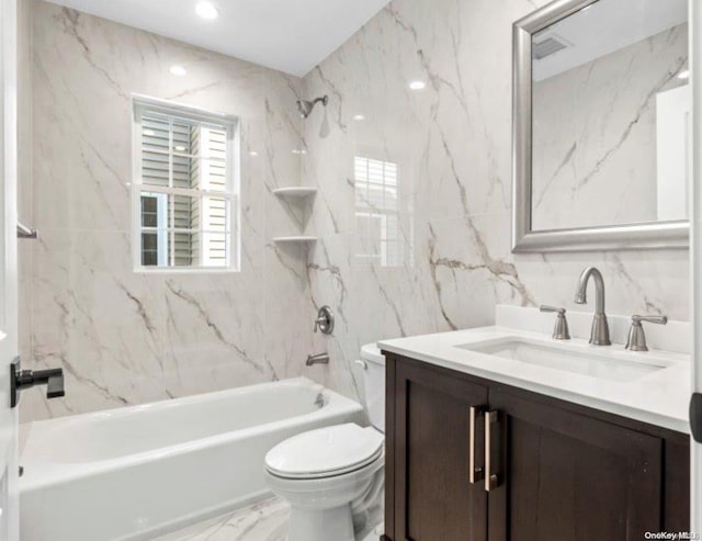 full bathroom featuring tile walls, vanity, tiled shower / bath combo, and toilet