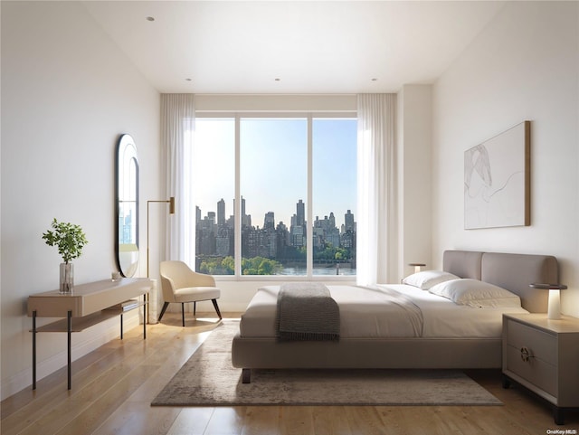 bedroom with light hardwood / wood-style floors and multiple windows