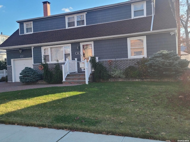 view of front facade featuring a garage and a front lawn