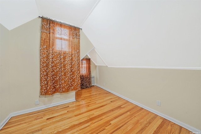 bonus room featuring wood-type flooring and vaulted ceiling