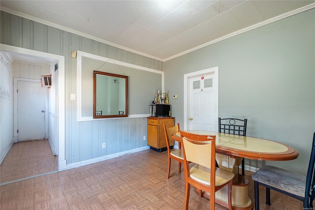 dining area with a wall mounted air conditioner, ornamental molding, and light parquet floors