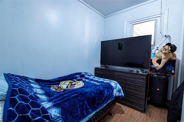 bedroom with parquet floors and crown molding