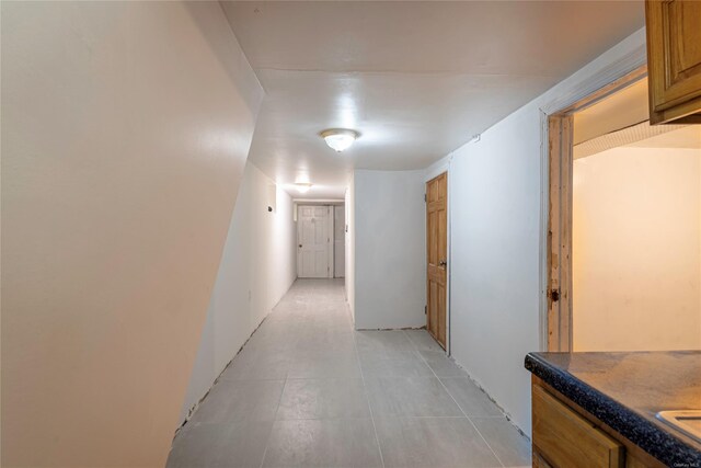 hallway featuring light tile patterned flooring