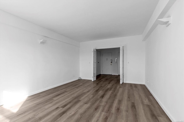 spare room with dark wood-type flooring