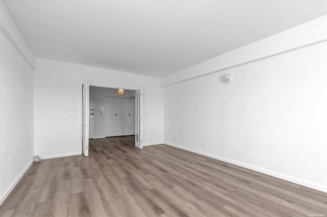 spare room featuring light hardwood / wood-style floors