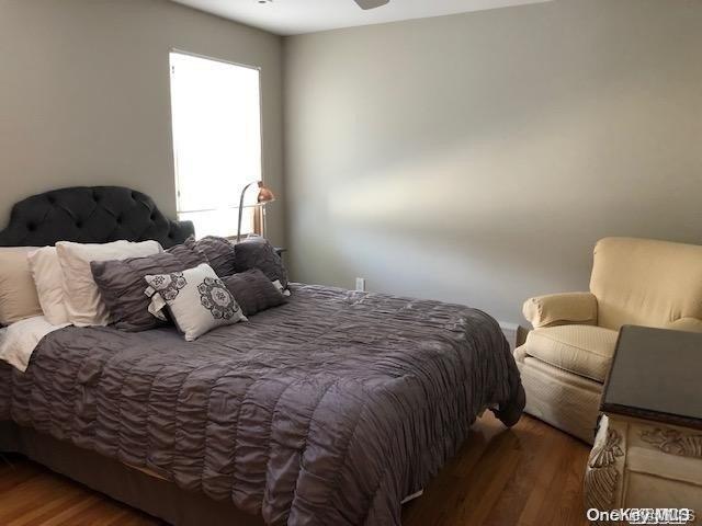 bedroom with dark hardwood / wood-style floors